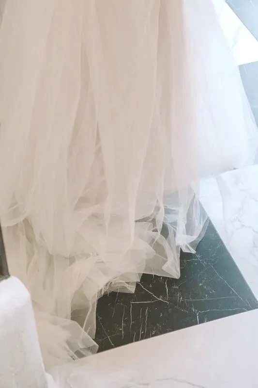 A bridal gown and tulle train, from a Veni Vidi Amavi wedding